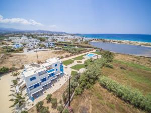 an aerial view of a building next to the ocean at Agyra Studios in Agios Prokopios