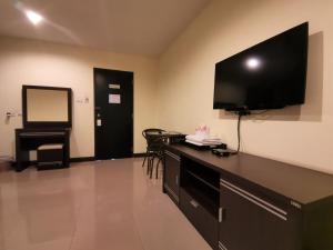a room with a flat screen tv on the wall at Phupara Place SHA Certified in Phuket Town