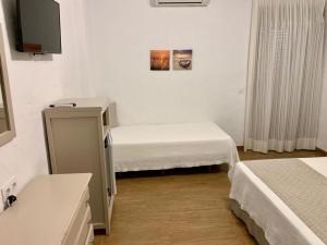 
a hotel room with a bed and a desk at Hotel Almadrabeta in Zahara de los Atunes
