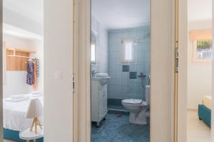 a bathroom with a toilet and a sink at Naftilos Residences I in Potokáki