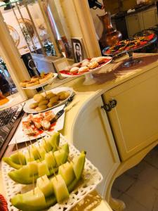 a kitchen counter with several plates of food on it at 2 KITARRAT Boutique Hotel & SPA in Durrës