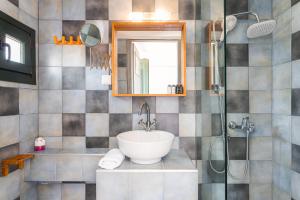 a bathroom with a sink and a shower at Naftilos Residences I in Potokáki