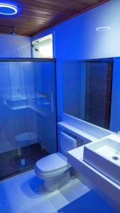 a blue bathroom with a toilet and a sink at Praia da Crena in Abraão