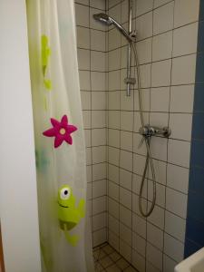 a shower with a shower curtain with a flower on it at Le Yanis in Lausanne +29 photos