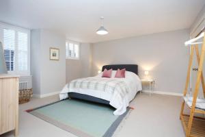 a bedroom with a bed with pink pillows on it at ALTIDO Vibrant 2 Bedroom Apartment in City Centre in Edinburgh