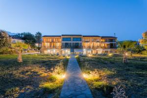 a building with a pathway leading to it at night at Naftilos Residences I in Potokáki