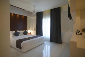 a bedroom with a large bed and a window at Boon Inn in Malappuram
