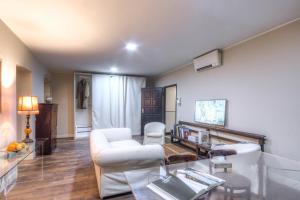 a living room with a white couch and a table at Right House di Via Sulis - Best Neighborhood in the Town in Cagliari