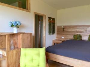 a bedroom with a blue bed and wooden cabinets at Karibuni - Familiar Lodging & Private Spa in Villarrica