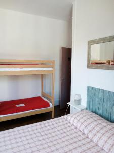 a bedroom with two bunk beds and a red mattress at Les 4 Montagnes in Villard-de-Lans