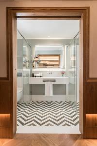 a bathroom with a sink and a mirror at Palacio Solecio, a Small Luxury Hotel of the World in Málaga