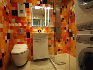 a small bathroom with a toilet and a mirror at Grand-Tourist Amber Center Apartments in Gdańsk