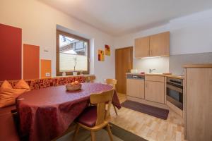 a kitchen with a table with a table cloth on it at Appartements Gerhard in Telfes im Stubai