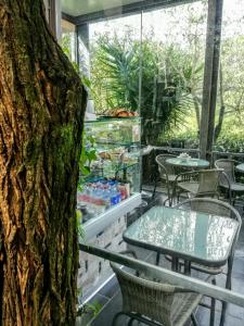 a patio with a table and chairs and a tree at Costa Morroni in Levanto