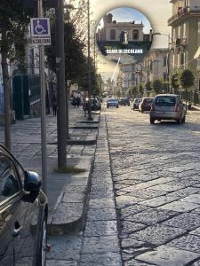 een geplaveide straat met auto's op de weg bij B&B Enjoy Ercolano in Ercolano