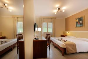Postel nebo postele na pokoji v ubytování Hotel Michelangelo