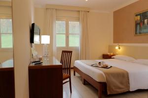 Postel nebo postele na pokoji v ubytování Hotel Michelangelo