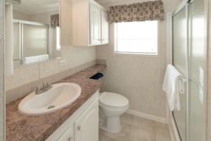 a bathroom with a sink and a toilet at Buttonwood Bay in Sebring +24 photos