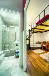 a bedroom with a bunk bed and a bathroom at Old Town Kanonia Hostel & Apartments in Warsaw