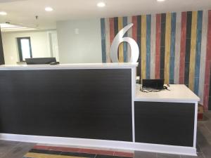 a reception desk with a letter k on a wall at Motel 6-Burnsville, MN in Burnsville