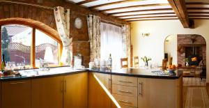 a kitchen with a sink and a large window at Humble Bee Cottage in Folkton