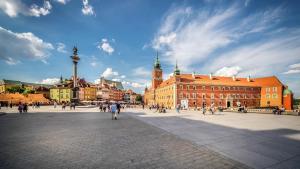 a group of people walking around a city square at Old Town Kanonia Hostel & Apartments in Warsaw +147 photos