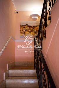 a staircase in a house with a sign on the wall at Villa della Fonte in Rome