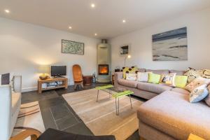 a living room with a couch and a tv at No2 The Fish Cellars in Port Isaac