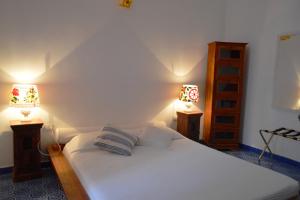 Кровать или кровати в номере Casa Perla