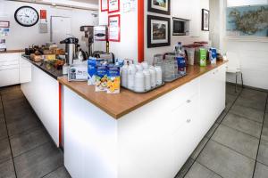 a kitchen with a counter top with bottles of milk at Guesthouse Aurora in Reykjavík