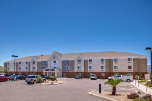 a large building with cars parked in a parking lot at Candlewood Suites Sierra Vista by IHG in Sierra Vista