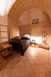 a bedroom with a bed in a brick room at Casa Masiello La casa tipica dei Sassi di Matera in Matera