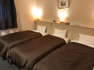 Postel nebo postele na pokoji v ubytování Hotel Avan Sukumo