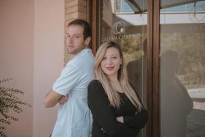 a man and a woman standing in front of a door at Hotel Caluna Charme in San Giovanni a Piro