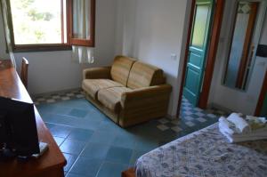 - un salon avec un canapé et une chaise dans l'établissement Guardia dei Mori, à Carloforte
