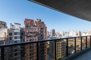 a view of a city from a balcony at AT Suites in Córdoba