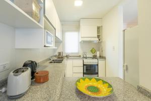 a kitchen with a counter with a sunflower bowl on it at AT Suites in Córdoba