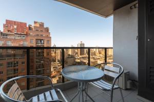 a table and chairs on a balcony with a view at AT Suites in Córdoba