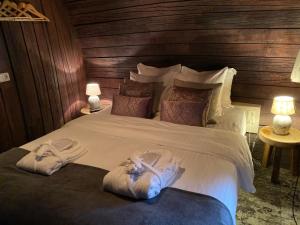 a bedroom with a large bed with two towels on it at Hotel De Vrouwe van Stavoren in Stavoren