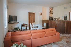a living room with a couch and a table at Hotel Caluna Charme in San Giovanni a Piro