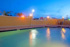 a pool of water next to a lighted walkway at Holiday Inn Express Hotel & Suites Chaffee - Jacksonville West, an IHG Hotel in Jacksonville