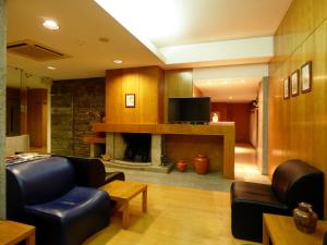 a living room with a couch and a fireplace at Hotel Nordeste Shalom in Bragança