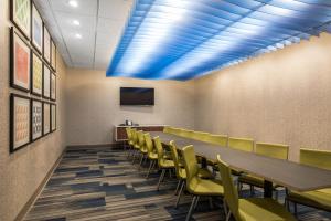 a conference room with a long table and yellow chairs at Holiday Inn Express & Suites Ludington by IHG in Ludington +23 photos