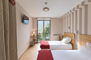 Säng eller sängar i ett rum på Hôtel Tourmalet