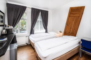 Rúm í herbergi á Guesthouse Andrea