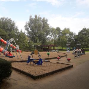 a park with a playground with slides and play equipment at Residentie Romanza in Middelkerke