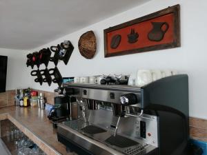 a kitchen with a coffee machine on a counter at Terrazas de San Agustin Hotel in San Agustín