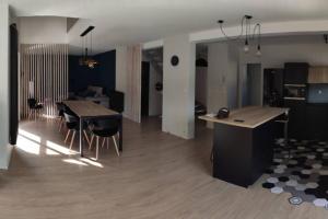 a living room and kitchen with a table and chairs at demoiselle Loue in Ornans