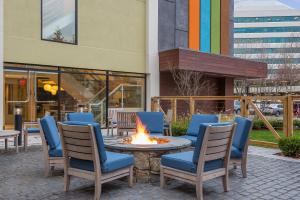 a fire pit outside of a building with chairs around it at EVEN Hotel Norwalk by IHG in Norwalk