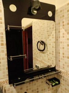 a bathroom with a large mirror on the wall at hotel arganier tafraoute in Tafraoute